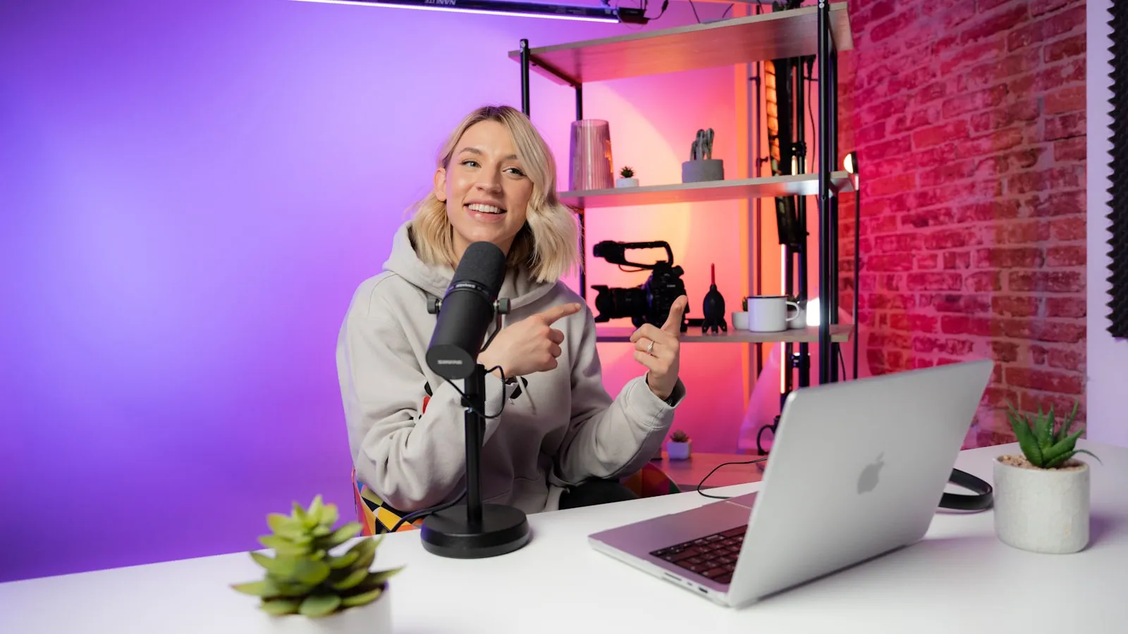 Creator recording video content in front of a laptop and microphone