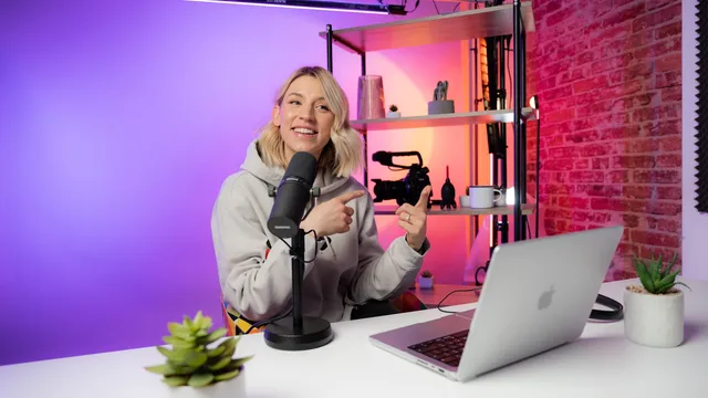 Creator recording video content in front of a laptop and microphone