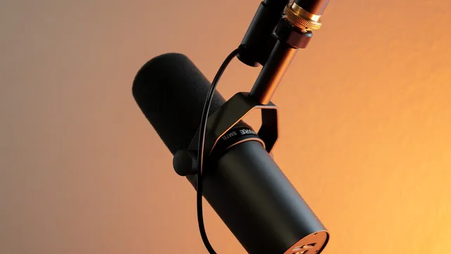 Studio microphone in warm light set up for podcast recording